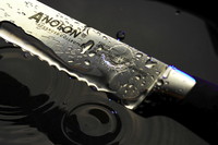Closeup of a knife above ripples in water