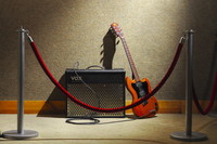 Guitar and amp behind a corrdon